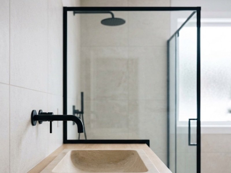 Newly renovated bathroom with a wall-mounted tap and tiled walls